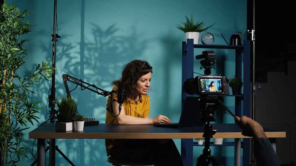 Marketer recording a promotional video to enhance marketing and advertising performance through storytelling and visual branding.